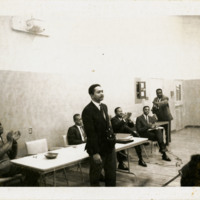 Merv Dymnally, Bill Green, Harold Brown, and others at a talk in a gymnasium