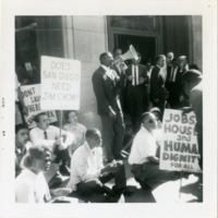 Harold Brown speaks into a megaphone at the Bank of America sit-in, 1964