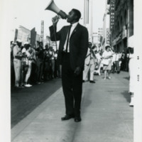 Harold Brown holding a megaphone, 1964