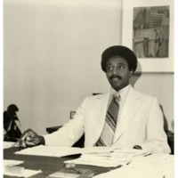 Harold Brown sitting at a desk
